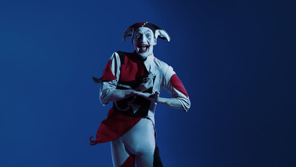 Joker displaying casino chip with enthusiastic playful mood. Concept of gaming advertising, casino branding, entertainment visuals, and promo storytelling with energetic character expression.