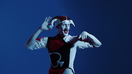 Jester presenting casino chip in expressive playful gesture. Concept of entertainment visuals, casino promotions, gaming banners, and character-driven branding with lively cheerful emotion.