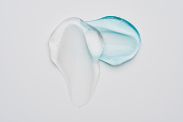 Pure transparent cosmetic gel smear on white background, skin care glycerin texture. top view.
