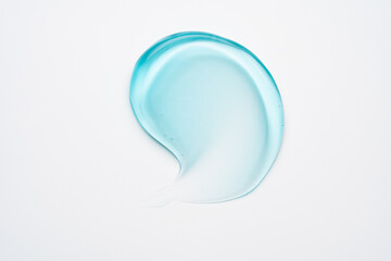 Glycerin gel texture. Transparent blue serum drop on white background. Liquid gel moisturizer with bubbles macro.