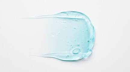 Squeezed cosmetic clear cream gel texture Isolated on white background. Close up transparent serum drop smear.
