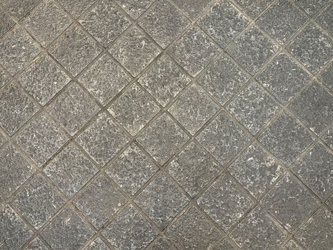 Flat andesite slate stone or grey paving stone in diamond shape pattern. Suitable for wall finishes, cladding, or outdoor floor materials. for pavement and sidewalk. Seamless background texture.