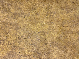 Decorative yellow gold washed paint on a surface. Random weathered golden textured paint with grunge, bark, and dirt pattern. Seamless background texture.      