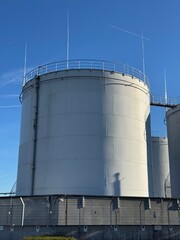 Large white tank with a blue sky in the background