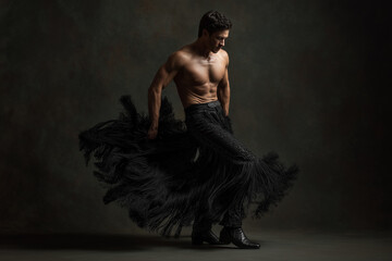 Stunning male flamenco dancer in dark background 