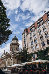 Historic architecture and outdoor cafes in a bustling European urban setting.