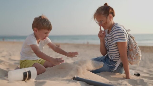 Mother and son building a sandcastle on the beach