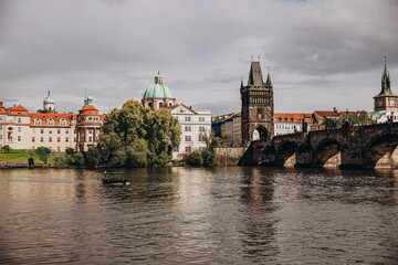 Scenic view of historic Charles Bridge and riverside architecture in Prague.