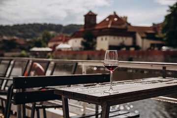 Serene riverside afternoon with a glass of red wine.