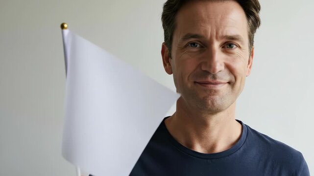 Man in blue shirt holding white flag, symbolizing surrender or truce. Peaceful gesture for negotiation and unity concept.