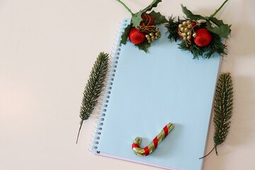 Blue notebook with Christmas ornaments. Background, empty space for text. Christmas concept. 