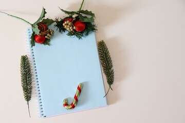 Blue notebook with Christmas ornaments. Background, empty space for text. Christmas concept. 