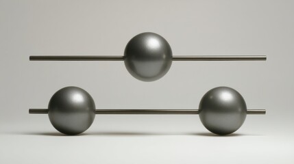 Three equal-sized metallic spheres arranged horizontally in a straight line on a light-colored background,