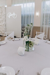 Elegant family gathering table setting with floral centerpiece and modern decor.