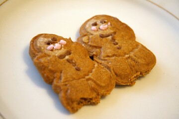 2 baked gingerbread human figures stuck together symbolizing Christmas, love, friendship and togetherness.
