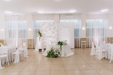 Elegant banquet hall setup with floral decorations and family theme design for events.