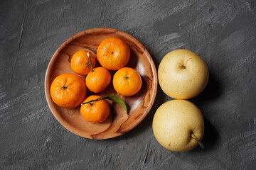 Oranges and pear on the table