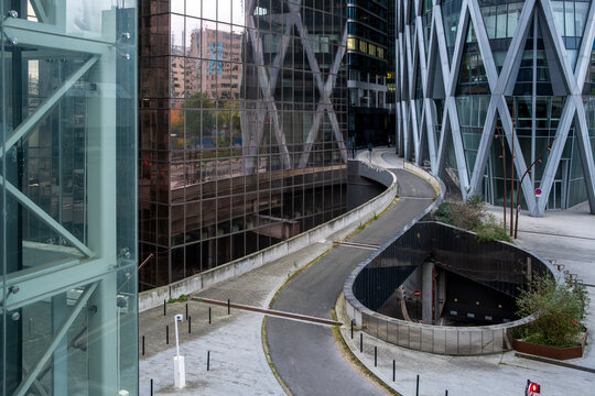 Corporate architecture with sweeping reflection guiding modern urban movement through la defense in paris france at the heart of the financial district