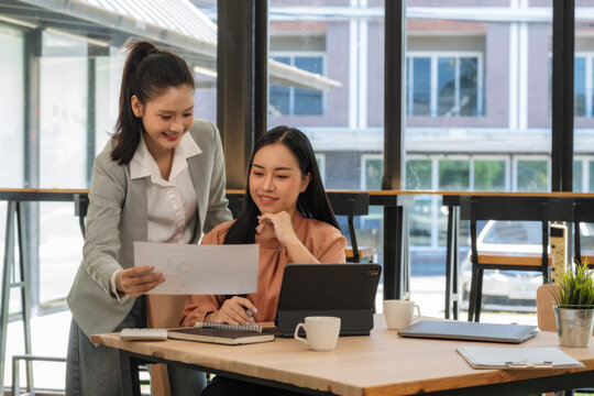A young business team is working on a business report document on the office desk. Brainstorming Business People Design Planning, Brainstorming Planning Partnership.