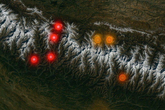 Snow capped mountain range with glowing red and orange border markers highlighting strategic high passes and peaks in dramatic aerial landscape, atmospheric and high contrast