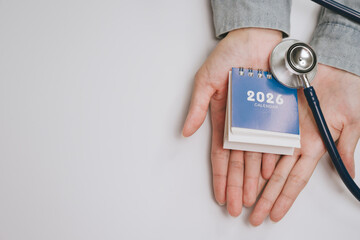 2026 calendar with stethoscope on open hand, medical concept for health planning and appointment reminder, healthcare and time management