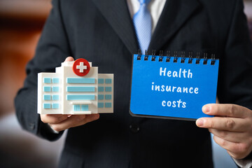 Health insurance costs concept. Reviewing medical bills and insurance documents, comparing plans, and managing expenses to ensure affordable and effective healthcare coverage. Hospital building, words