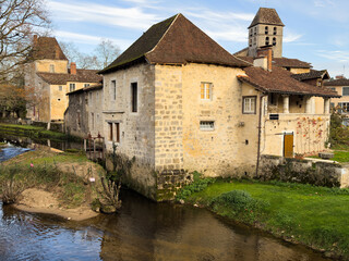 Picture of a beautiful river lined with stone houses in south of France. Countryside vacation background.