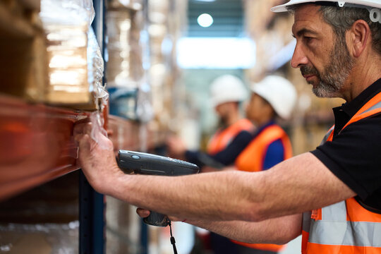 Warehouse worker scanning inventory with barcode reader