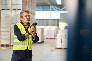 Man scanning inventory in logistics warehouse
