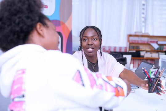 Two african girls interacting during the work time
