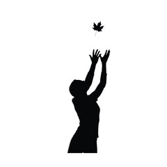 Woman reaching for a falling leaf silhouette