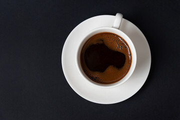 Minimalist top view of a coffee cup on dark background, perfect for food photography, cafe branding, menu design, and modern marketing visuals