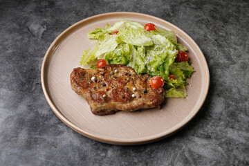 Savory Pan-Seared Steak With Crisp Salad On Beige Plate Over Dark Surface