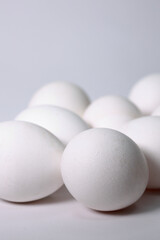 A Group Of Raw White Eggs Piled Randomly On A Smooth Surface. Minimalist Food Composition Representing Farm Products And Baking Ingredients.