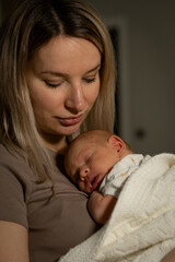 Mom soothing baby during quiet moment at home in the evening light