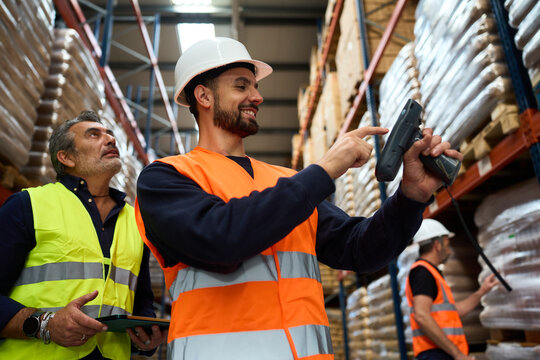 Warehouse workers scanning inventory with barcode reader