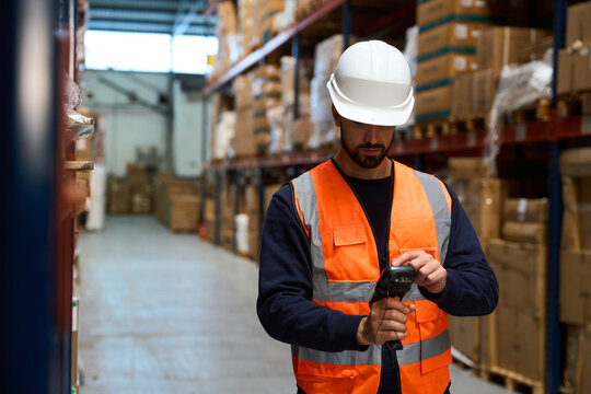 Warehouse worker scanning boxes for inventory management