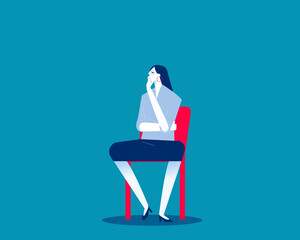 Thinking. Woman sitting on chair looks pensive and reflective