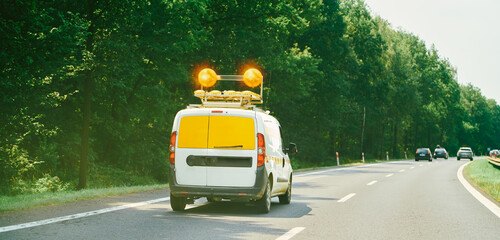 Road service vehicle on forest highway