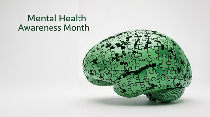 Assembled green brain puzzle symbolizing mental health awareness for Mental Health Awareness Month