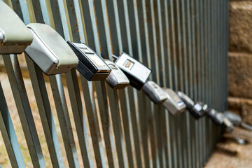 Padlocks with codes attached to gate bars