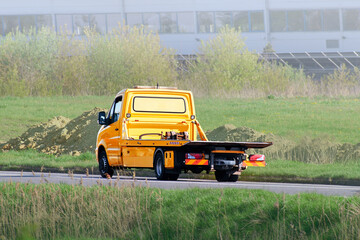 Light-duty tow truck with spare tire