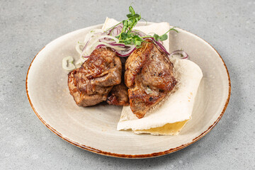 Grilled juicy pork pieces served on lavash with fresh sliced onions and herbs for restaurant menu, barbecue advertising, and food delivery promotion