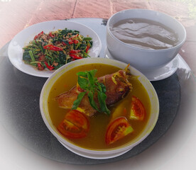 Typical Papuan menu: Yellow Fish Sauce. Usually served with kale, papaya flowers and papeda.