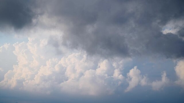 Time lapse of dynamic clouds moving over the mountains of Ruifang New Taipei City Taiwan in the winter afternoon. Combination of bright blue sky white clouds and dark gray clouds.
