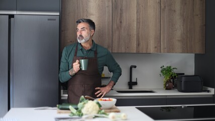 Mature man thinking while enjoying coffee breaking