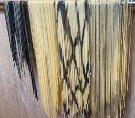 Fresh artisan fettuccine handmade with flour and eggs—long pasta ribbons crafted with care, capturing the rustic soul of traditional homemade Italian cuisine.