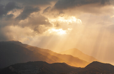 Beautiful mountains landscape after rain at the sunset and beautiful sun rays.