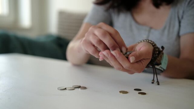 Girl Counts The Coins On A Table