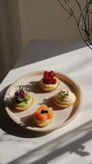 Mini tartlets: avocado lime mousse, cream cheese with salmon and pomegranate, and kimchi with tofu and microgreens
